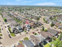 Residential neighborhood featuring varied single-family homes with mature trees and paved streets - 2418 32B Street, Edmonton, AB 
