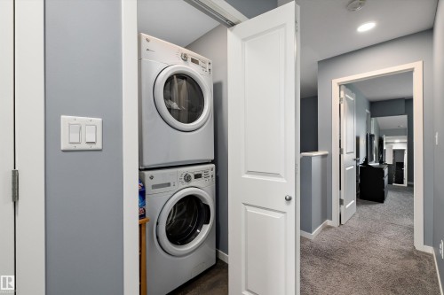 Dedicated laundry area featuring a stacked washer and dryer unit - 2833 Chokecherry Place, Edmonton, AB 