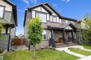 Contemporary two-story residence featuring a covered front porch with dark trim - 2833 Chokecherry Place, Edmonton, AB 