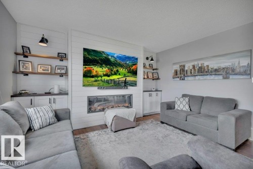 482 Reed Cres Leduc AB. Custom shiplap with built in fireplace, storage cabinet base, remote controlled wall sconces. - 482 Reed Crescent, Leduc, AB 