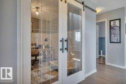 482 Reed Cres Leduc AB. Custom wainscoting and French doors. - 