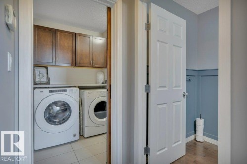 482 Reed Cres Leduc AB. Folding counter with storage above. Sliding barn door with motion señor lighting. - 482 Reed Crescent, Leduc, AB - Indoor Photo Showing Laundry Room