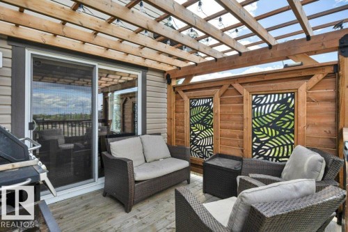 482 Reed Cres Leduc, AB . Custom pergola with privacy sides , solar lights and gas hook up over looking open spaces . - 482 Reed Crescent, Leduc, AB 
