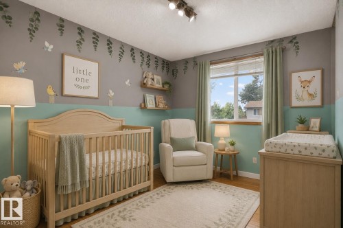 Spacious room featuring wood-finish flooring, a large window with blinds, and recessed ceiling track lighting - 13427 114 Street, Edmonton, AB 