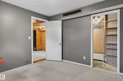 Carpeted room with gray walls and a textured white ceiling - 