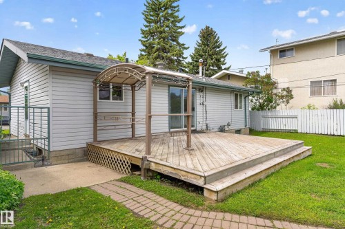Expansive wood deck with a built-in pergola, offering direct access to the interior via sliding glass doors - 13427 114 Street, Edmonton, AB 
