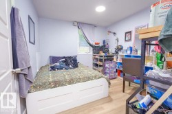 Room featuring wood-finish flooring, a single window with blinds, and recessed ceiling lighting - 