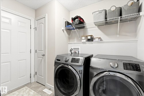 Utility space featuring light gray walls, white trim, and a textured ceiling - 3685 Westcliff Way, Edmonton, AB 
