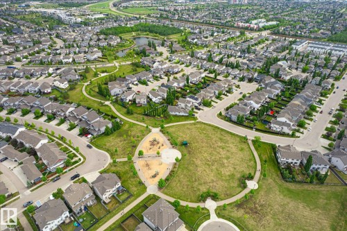 Aerial depiction of a residential community featuring extensive green spaces, a central park with playground structures, and a pond - 3685 Westcliff Way, Edmonton, AB 