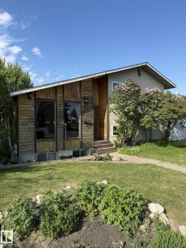 Split-level residence featuring a wood-panel facade, stucco siding, and a gabled roof - 16321 - 109A Ave, Edmonton, AB - Outdoor