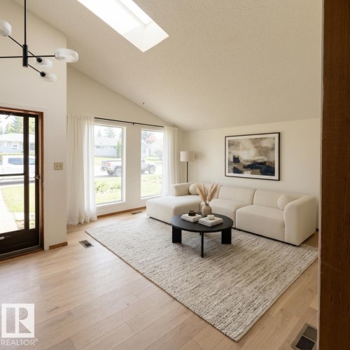Vaulted ceiling with an overhead skylight - 16321 - 109A Ave, Edmonton, AB - Indoor Photo Showing Living Room