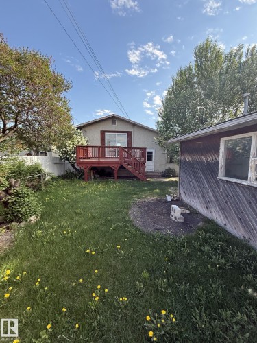 Rear exterior with a red-stained wood deck and staircase - 16321 - 109A Ave, Edmonton, AB - Outdoor With Deck Patio Veranda