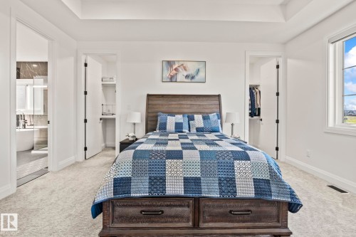 Bright bedroom featuring light gray carpeting and white walls - 23 Elwyck Gate, Spruce Grove, AB 