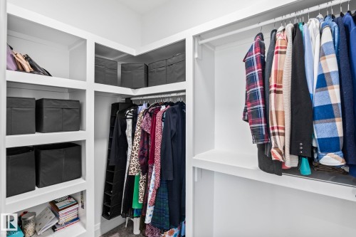 Custom-designed closet system featuring extensive shelving, multiple hanging rods, and integrated storage solutions - 23 Elwyck Gate, Spruce Grove, AB 