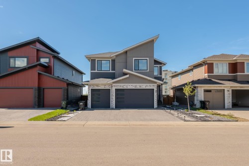 Contemporary two-story residence featuring a striking angular roofline and a multi-textured facade - 23 Elwyck Gate, Spruce Grove, AB 