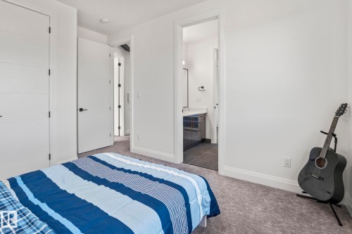 Bedroom featuring light gray carpeting and white walls - 23 Elwyck Gate, Spruce Grove, AB 