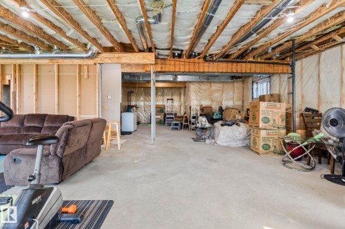 Unfinished basement offering expansive concrete flooring and exposed ceiling joists - 23 Elwyck Gate, Spruce Grove, AB 