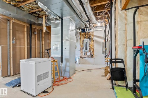 Unfinished basement space featuring exposed framing, visible ductwork, and electrical panel - 23 Elwyck Gate, Spruce Grove, AB 