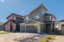 Contemporary two-story exterior featuring multi-toned siding and stonework accents - 23 Elwyck Gate, Spruce Grove, AB 