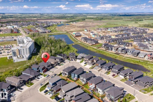 Aerial view of a residential neighborhood featuring a mix of single-family homes and multi-story apartment buildings - 23 Elwyck Gate, Spruce Grove, AB 