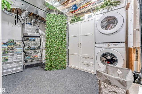Dedicated laundry area featuring stacked front-load washer and dryer units - 116 3305 Orchards Link Sw, Edmonton, AB 