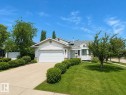 Siding exterior with an attached two-car garage, concrete driveway, and front lawn - 1 Munro Court, Leduc, AB 