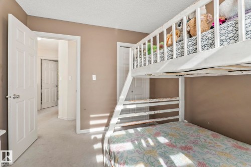 Carpeted bedroom with neutral wall tones and white trim - 220 85St, Edmonton, AB 