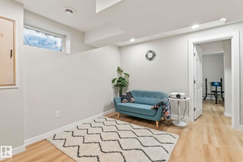 Recessed lighting illuminates this room featuring light wood-finish flooring and a white trim - 220 85St, Edmonton, AB 