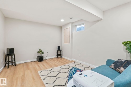 Finished room featuring wood-finish flooring, light-toned walls, and recessed lighting - 220 85St, Edmonton, AB 