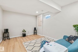 Finished room featuring wood-finish flooring, light-toned walls, and recessed lighting - 