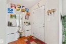 Entryway featuring wood-finish flooring, a white paneled door, and light-toned walls - 220 85St, Edmonton, AB 