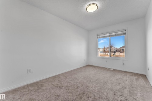 Bright room with neutral carpeting and white walls - 5405 Crabapple Loop, Edmonton, AB 