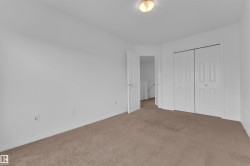 Carpeted room with white walls and baseboards - 