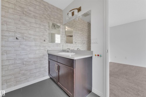 Bathroom featuring a single vanity with a white countertop and a dark wood-finish cabinet - 5405 Crabapple Loop, Edmonton, AB 
