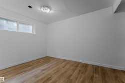 Room featuring wood-finish flooring, white baseboards, and a neutral wall palette - 