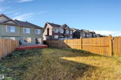 Rear exterior of the property featuring a private wood fence enclosing the backyard - 