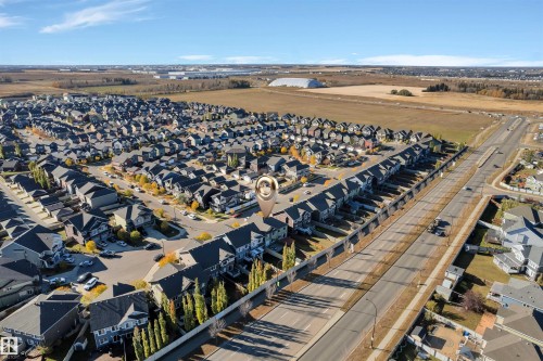 Aerial perspective of a residential community featuring rows of detached homes and townhouses - 5405 Crabapple Loop, Edmonton, AB 