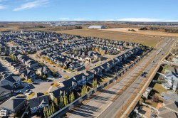 Aerial perspective of a residential community featuring rows of detached homes and townhouses - 