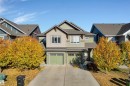 Contemporary facade featuring multi-tone siding, a dual-car garage, and a concrete driveway - 5405 Crabapple Loop, Edmonton, AB 