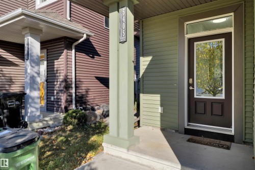 Welcoming entry features a dark-paneled door with a prominent glass insert and transom window - 5405 Crabapple Loop, Edmonton, AB 
