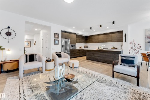 Open-concept living area with light wood-finish flooring - 6203 47 Avenue, Beaumont, AB 