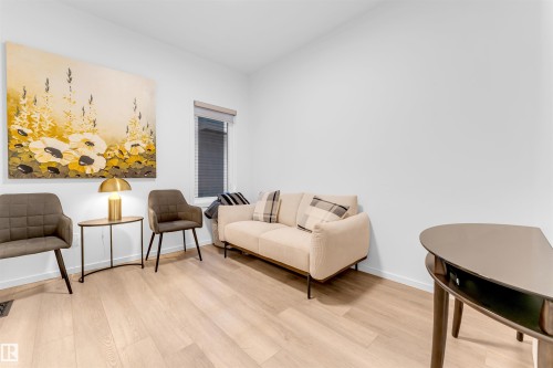 Light wood-finish flooring complements the neutral wall color - 6203 47 Avenue, Beaumont, AB 