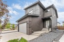 Contemporary multi-level exterior featuring dark horizontal siding and brick accents - 6203 47 Avenue, Beaumont, AB 