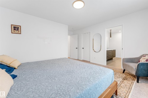 Room featuring light neutral carpeting, white walls, and a flush-mount ceiling light - 6203 47 Avenue, Beaumont, AB 
