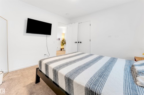 Carpeted room featuring white walls and white trim - 6203 47 Avenue, Beaumont, AB 