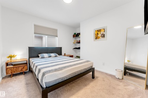 Bedroom featuring light-colored carpeting and white walls - 6203 47 Avenue, Beaumont, AB 
