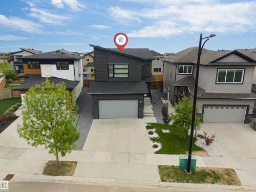 Modern architectural design featuring a prominent angled roofline and dark-toned siding - 6203 47 Avenue, Beaumont, AB 