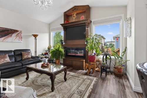 Living room featuring a vaulted ceiling and wood-finish flooring - 71 Ratelle Circle, St. Albert, AB 