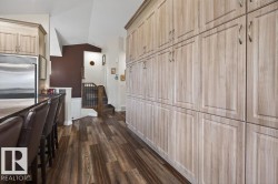 Expansive floor-to-ceiling cabinetry with wood-finish doors - 