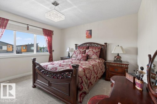 Spacious room featuring light-colored carpeting and a large window - 71 Ratelle Circle, St. Albert, AB 